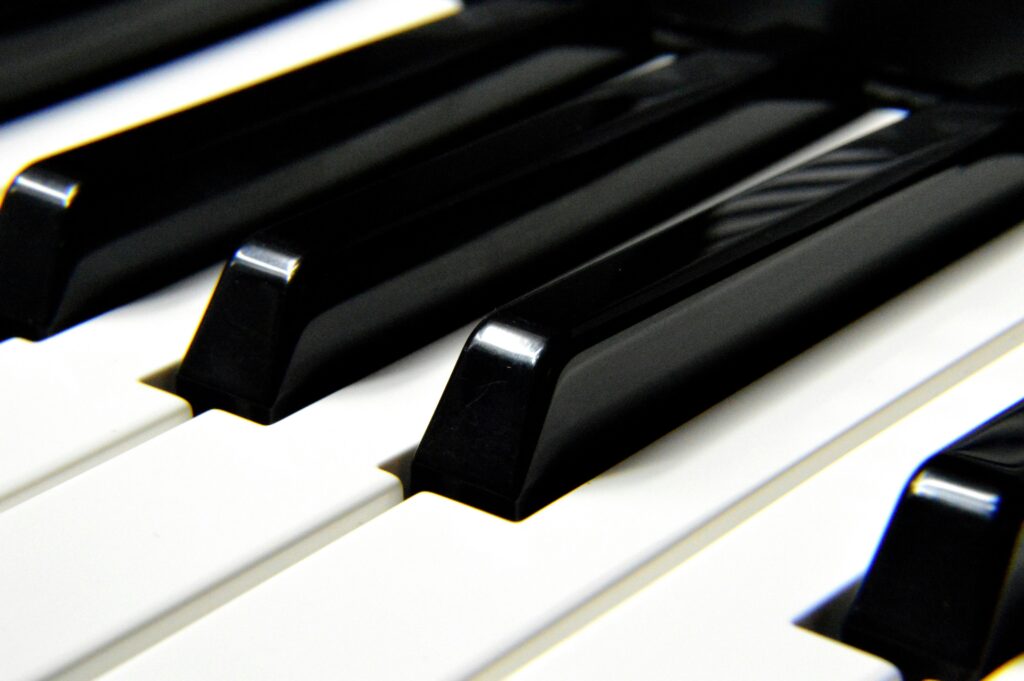 A detailed close-up shot focusing on black and white piano keys, highlighting musical harmony.