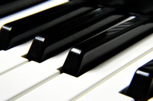 A detailed close-up shot focusing on black and white piano keys, highlighting musical harmony.